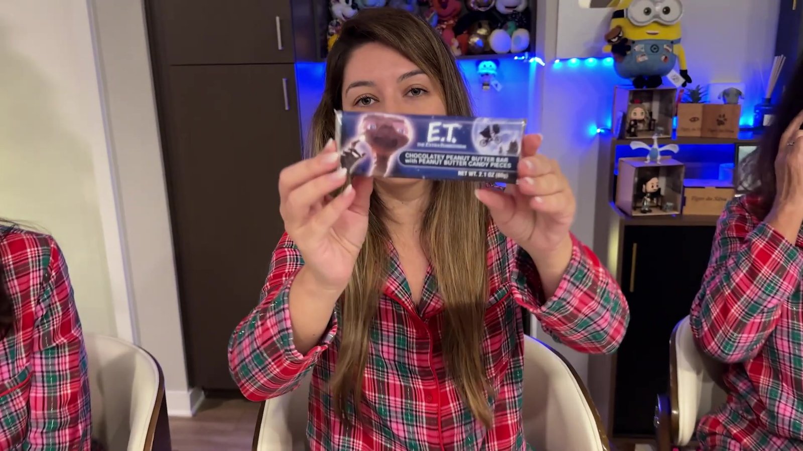 Gabi mostrando a embalagem do chocolate do E.T. da Universal, de pasta de amendoim com M&Ms