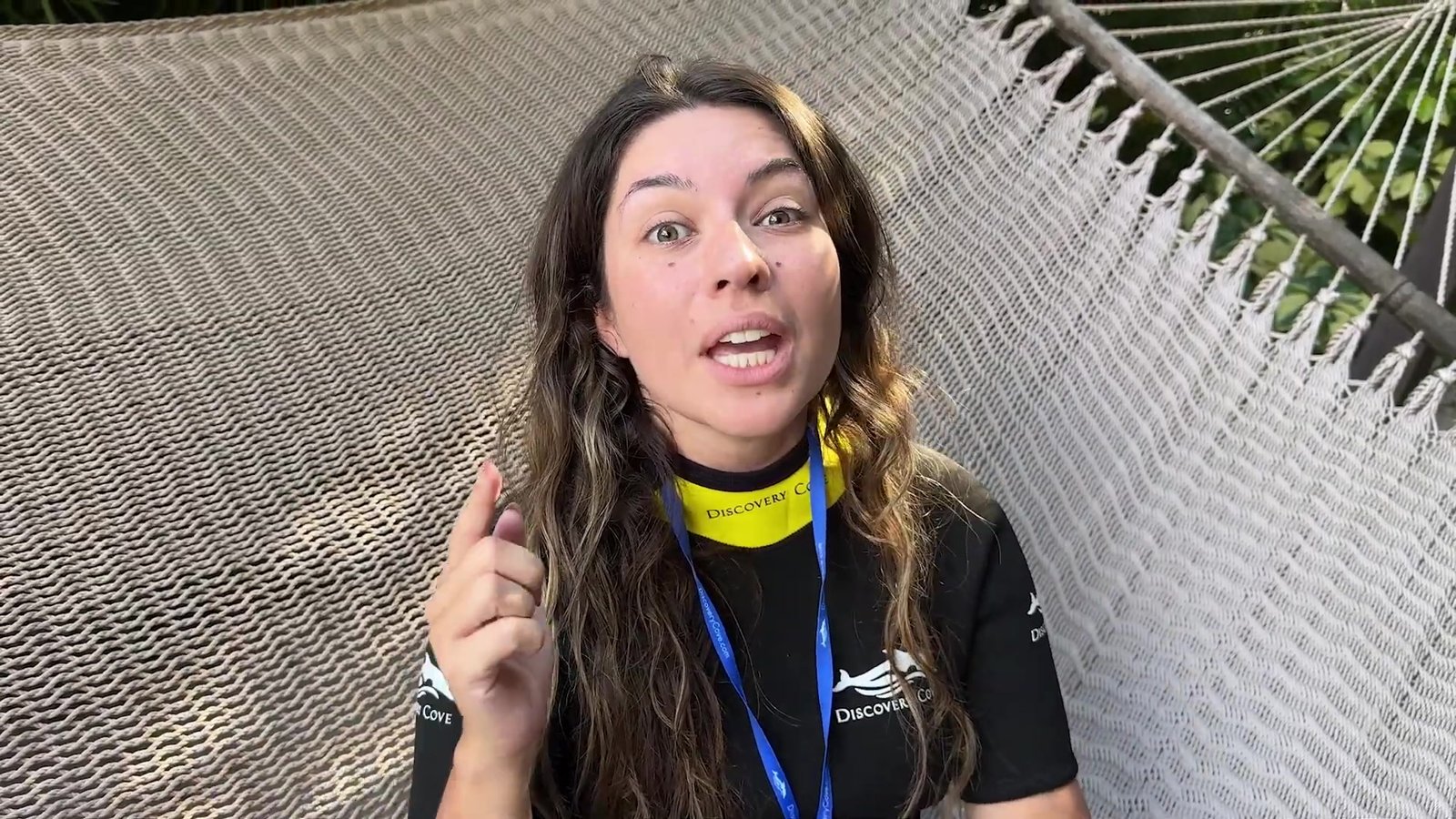 Gabi deitada na rede da cabana do Discovery Cove, de roupa térmica