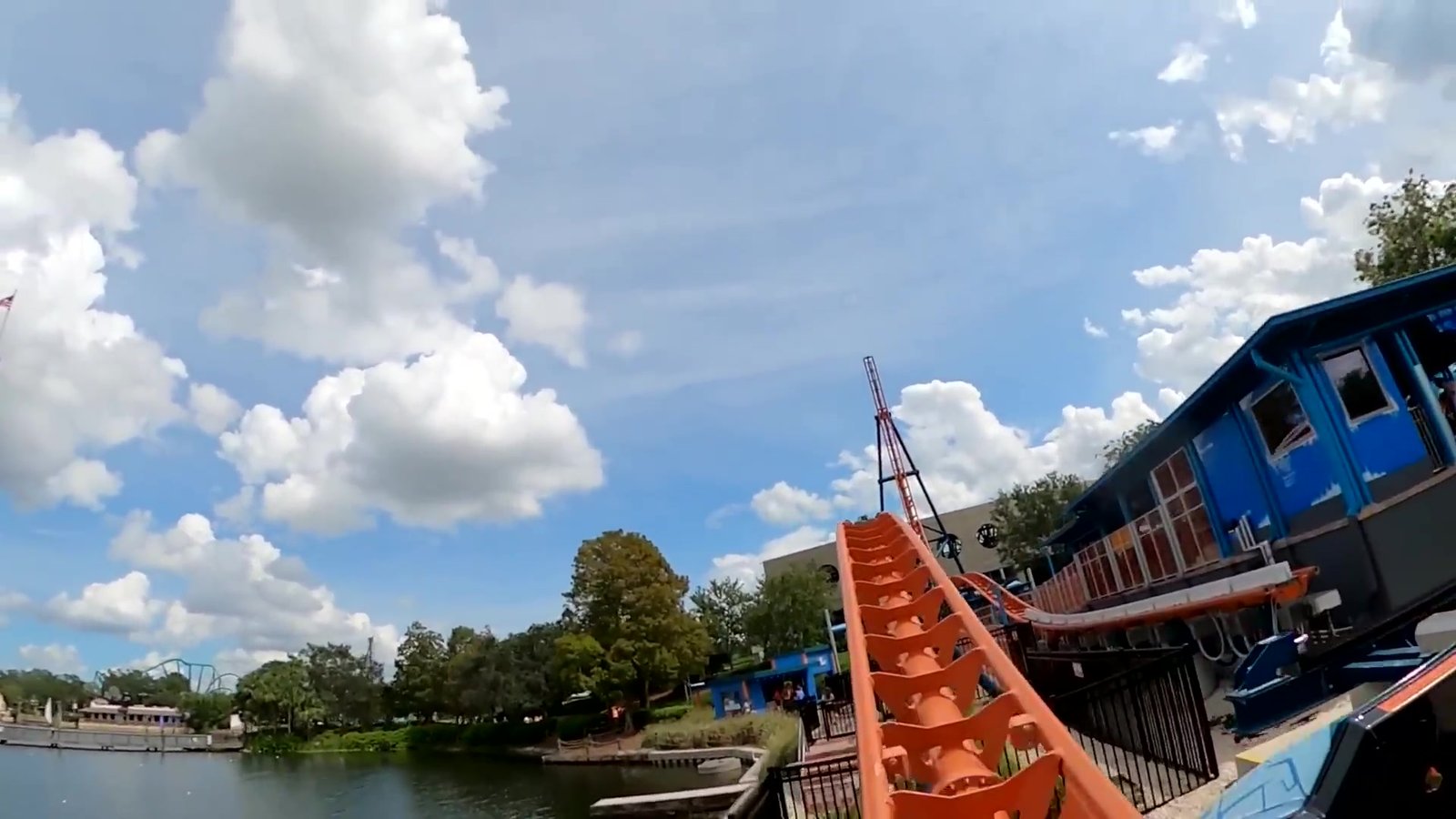 Lago do SeaWorld com a montanha-russa Ice Breaker e o céu azul de Orlando