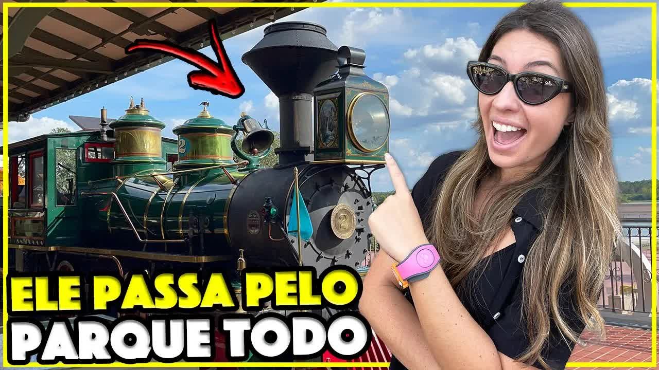 Gabi apontando para a locomotiva verde do trem do Magic Kingdom na estação da Main Street