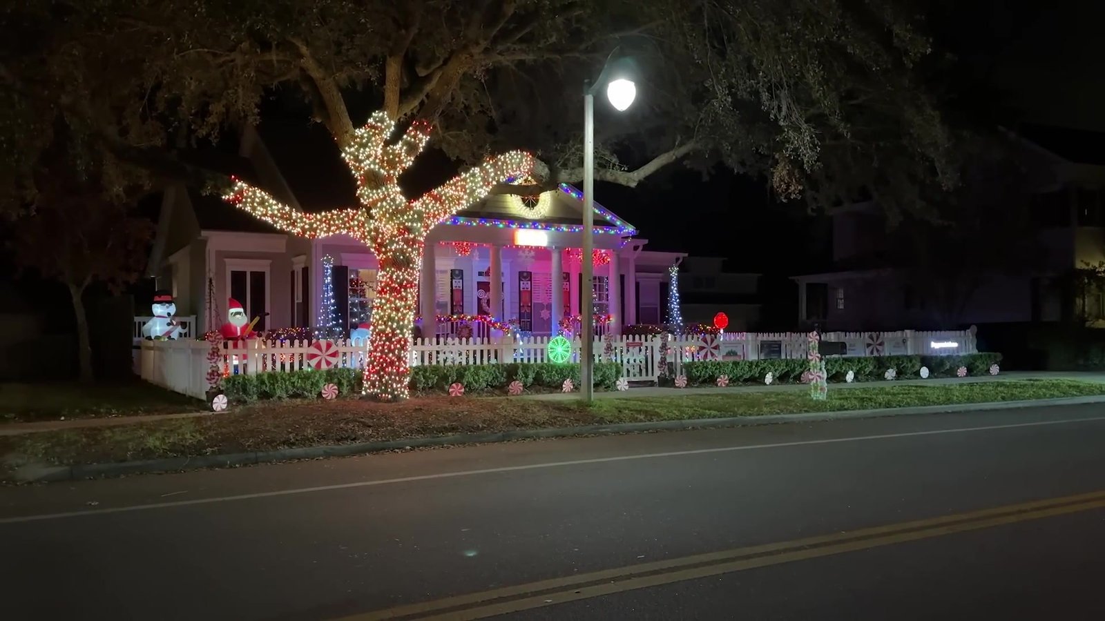 Casa com árvore coberta de luzes brancas e cerca decorada em Celebration